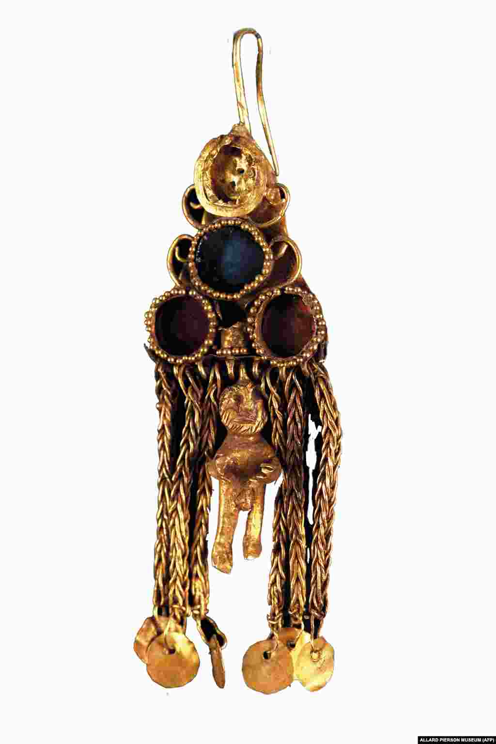 A second-century A.D. golden earring with glass inlay and figurine, found in a woman&#39;s grave at the necropolis of Ust-Alma.