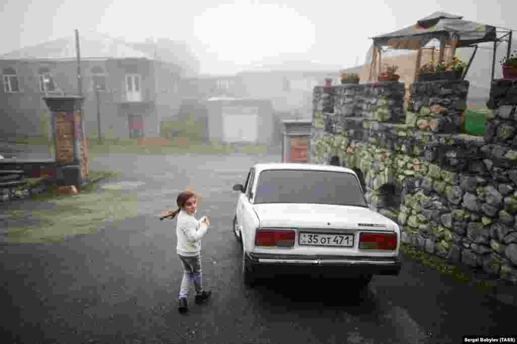 A girl walks near a hotel where refugees from Nagorno-Karabakh have been accommodated in the Armenian border city of Goris. (TASS/Sergei Bobylev)