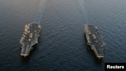 The Nimitz-class U.S. aircraft carriers "USS Abraham Lincoln" and "USS John C. Stennis" are seen in the Arabian Sea in January.