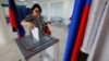 A voter casts her ballot at a polling station during elections for Russian-installed legislatures in Donetsk, Russian-controlled Ukraine, on September 8. Ukraine's Foreign Ministry called the elections a "sham." 