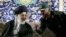 Iran's Supreme Leader Ayatollah Ali Khamenei (left) listens to Revolutionary Guards Commander Mohamad Ali Jafari during a ceremony in Tehran last month. Both Khamenei and the Revolutionary Guards are among those with the most to lose if the current system unravels in Iran.