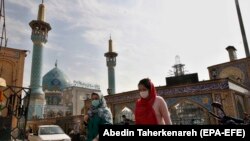 IRAN -- Iranian women wearing face masks walk past next to the Saleh shrine in Tehran, October 26, 2020