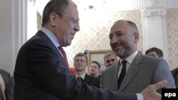 Russian Foreign Minister Sergei Lavrov (L) welcomes Afghan National Security Advisor Hanif Atmar during their meeting in Moscow on April 15.