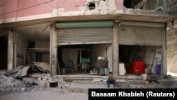 A destroyed shop in the eastern Damascus suburb of Ghouta on July 19.