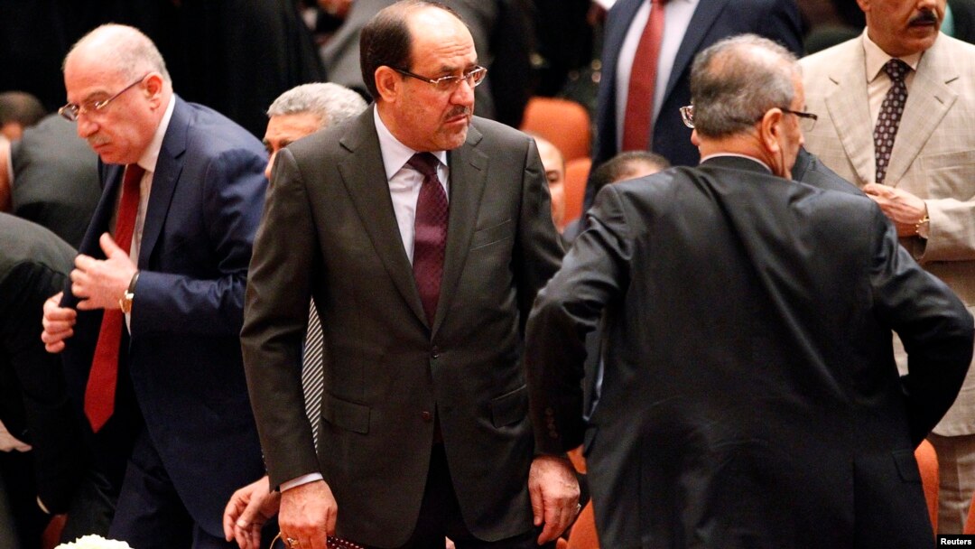 Iraqi Prime Minister Nuri al-Maliki (center) attends a session of parliament in Baghdad on July 1.