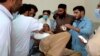 One of the passengers injured in a Balochistan bus accident on June 11 receives treatment at a hospital in the Khuzdar district.