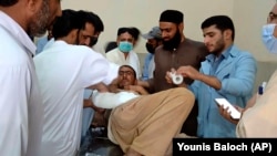 One of the passengers injured in a Balochistan bus accident on June 11 receives treatment at a hospital in the Khuzdar district.