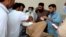 One of the passengers injured in a Balochistan bus accident on June 11 receives treatment at a hospital in the Khuzdar district.