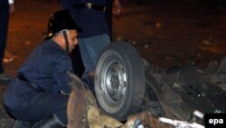 Security officer examines a blast site on a highway near the airport in Mumbai 