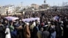 Mourners on February 7 attend a funeral for victims of an attack at a Shi'ite mosque a day earlier in Islamabad.