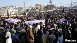 Mourners on February 7 attend a funeral for victims of an attack at a Shi'ite mosque a day earlier in Islamabad.