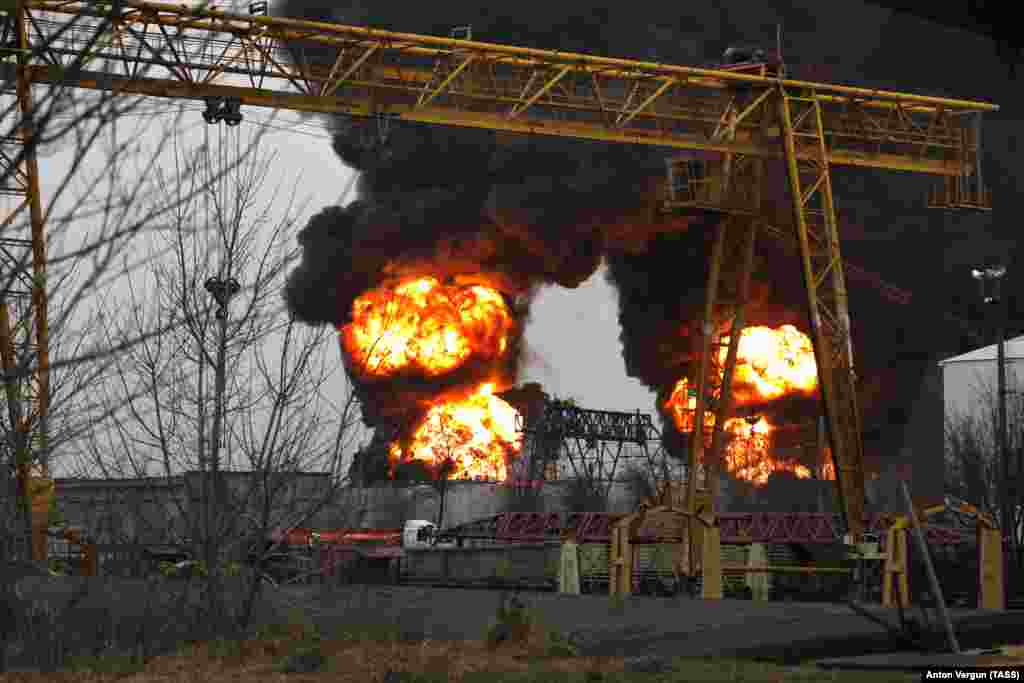 Fireballs rise over an oil depot in Belgorod, a Russian city located 30 kilometers from the border with Ukraine, on April 1. According to a local official, the fire was caused by an air strike from two Ukrainian helicopters. Video of the aftermath of the dawn incident shows two Hind helicopter gunships skimming the rooftops of the southwestern Russian city. Ukraine denied any involvement.&nbsp;