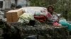 A detail from a Reuters photo showing Russian soldiers atop an armored vehicle in the Ukrainian town of Popasna with household items that Alina Korenyuk says were stolen from her home. 