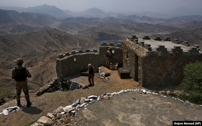 Pakistani troops watch from a hilltop post near Pakistan’s border with Afghanistan in the Khyber district.