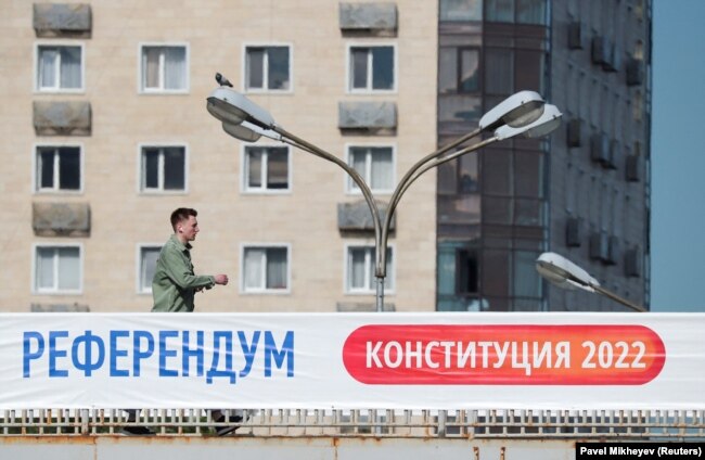 A banner on a bridge in Almaty reads, "Referendum. Constitution 2022." Nazarbaev