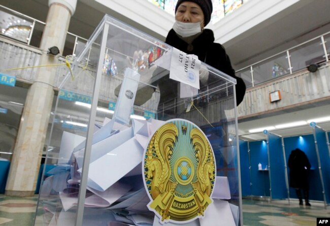 A woman votes during Kazakhstan's parliamentary election in Nur-Sultan on January 10, 2021.