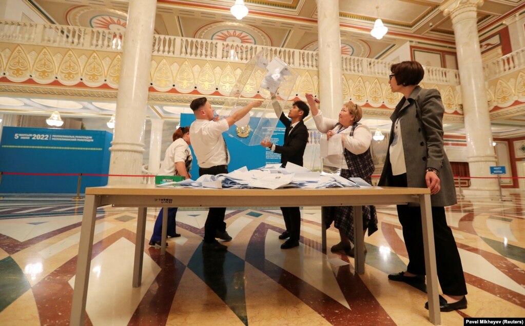 Anëtarët e një komisioni zgjedhor duke hapur një&nbsp;kuti votimi, pasi qendrat e votimit u mbyllën gjatë një referendumi kushtetues në Kazakistan. Qendër votimi në Nur-Sulltan, 5 qershor.