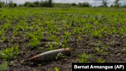 Një mjet shpërthyes shihet në një tokë bujqësore në Ukrainë. 