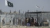 Afghan and Pakistani nationals walk through a security barrier at the Pakistan-Afghanistan border crossing point in Chaman. (file photo)