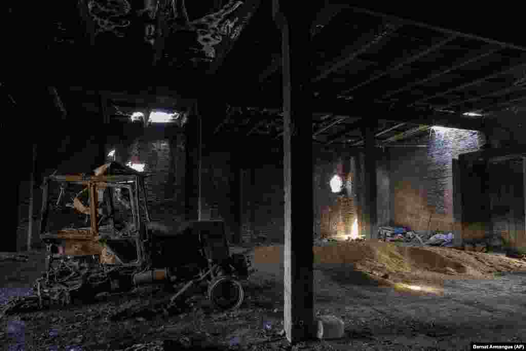 A tractor charred by a Russian attack lies inside a warehouse at a grain farm in Cherkaska Lozova, near Kharkiv, on May 28. &quot;It&#39;s an almost grotesque situation we see at the moment in Ukraine, with nearly 25 million metric tons of grain that could be exported but that cannot leave the country simply because of lack of infrastructure, the blockade of the ports,&quot; said Josef Schmidhuber, a deputy director at the UN&#39;s Food And Agriculture Organization. Ukraine, its neighbors, and the EU, are now scrambling to find other routes to get Ukrainian grain to markets, with rail emerging as a viable option despite many logistical challenges. &nbsp;