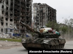 The Reuters photo of the Russian armored vehicle with what appear to be looted items in Popasna on May 26.