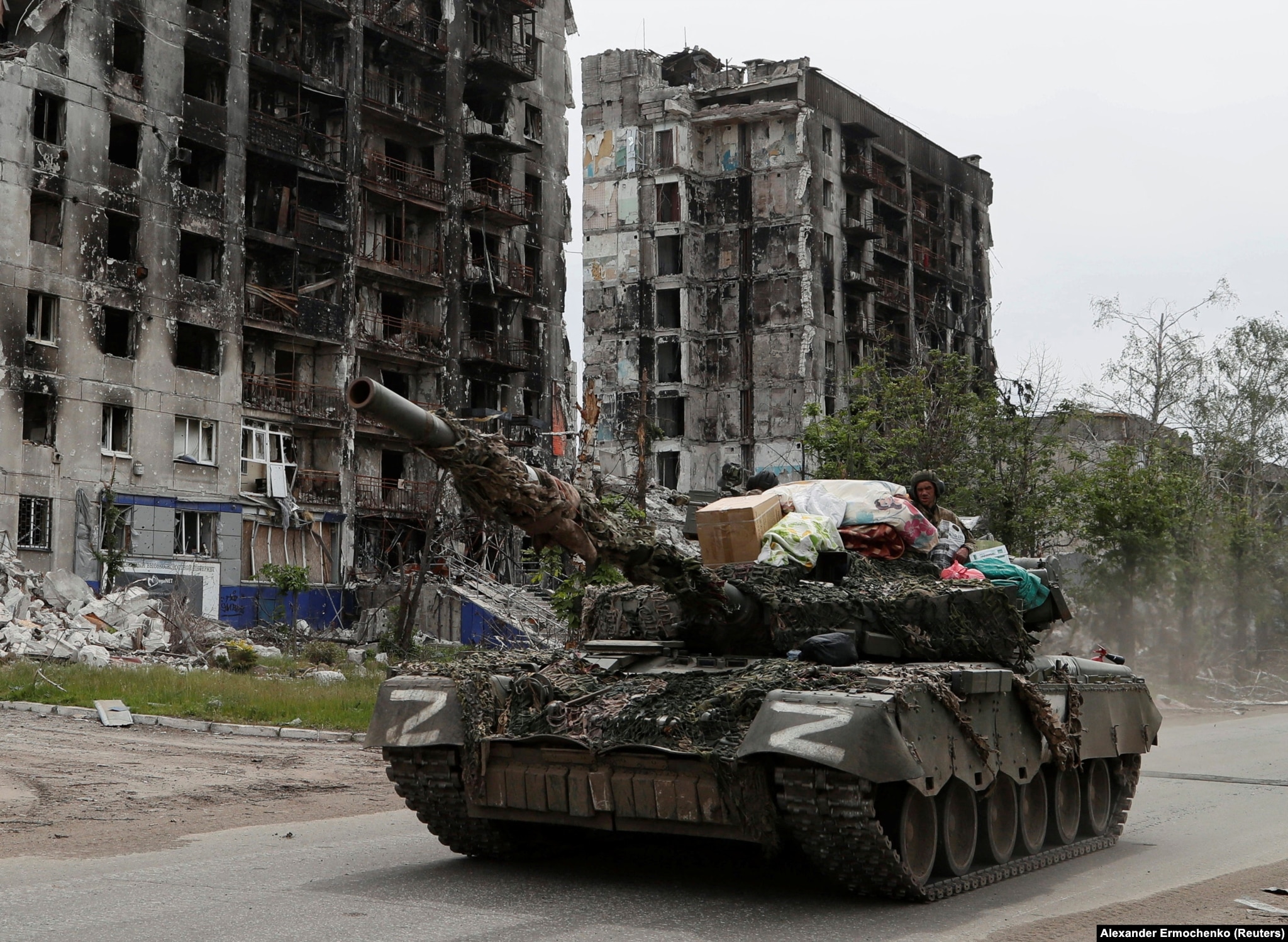 A tank manned by Russia-backed separatists drives through the streets of Popasna in May 2022.