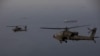 A handout photo released by US Central Command on April 18 shows AH-64 Apaches flying above the Strait of Hormuz during a patrol on April 17.