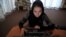 A woman browses on a computer at a women-only Internet cafe in Kabul.