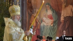 Russian Patriarch Kirill (left) leads the Orthodox Christmas service at the Cathedral of Christ the Savior in Moscow on January 7, with Russian Prime Minister Dmitry Medvedev in attendance.