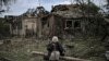 An elderly woman sits in front of houses on June 5 that have been destroyed by a missile strike in Druzhkivka.&nbsp;The city is located 32 kilometers south of Slovyansk, where Russian forces are continuing their offensive to capture the Donbas region.