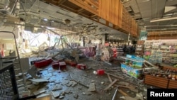 A supermarket in a shopping mall damaged by a Russian missile strike in Kharkiv on June 8. Amnesty says 606 civilians have been killed and 1,248 wounded since Russia began its invasion of Ukraine on February 24.