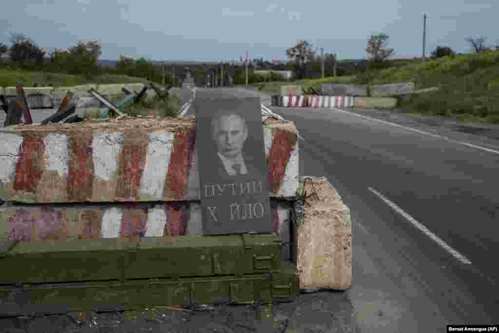 A tombstone depicting Russian President Vladimir Putin with the commonly used phrase &quot;Putin dickhead&quot; is seen at a Ukrainian checkpoint in the Donetsk region.&nbsp;