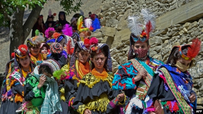 Kalash women wear traditional dresses during a religious festival celebrating the arrival of spring in Bumburet. (file photo)