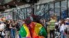 Participants march during a pride parade in Pristina, Kosovo, on June 9.