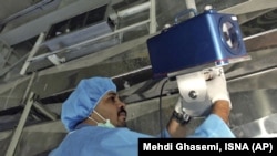 An inspector from the International Atomic Energy Agency sets up surveillance equipment at a nuclear facility in Iran. (file photo)
