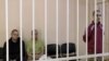 Britons Aiden Aslin and Shaun Pinner and Moroccan Saaudun Brahim, who were captured by Russian forces in Ukraine, sit in a courtroom cage in Donetsk on June 8.