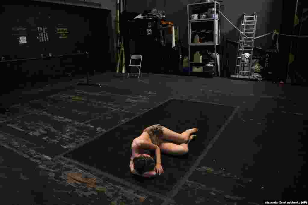 A participant in the International Ballet Competition rests backstage after performing at the Bolshoi Theater in Moscow.&nbsp;