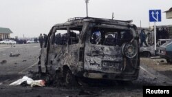 Daghestan -- A view shows a burnt vehicle near a damaged traffic checkpoint near the town of Derbent, February 15, 2016