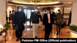 Pakistani Prime Minister Imran Khan visits ISI headquarters in November 2020 accompanied by army chief General Qamar Javed Bajwa (center) and outgoing ISI head Faiz Hameed (right). 