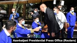 AZERBAIJAN -- Azerbaijani President Ilham Aliyev and his wife Mehriban visit the Central Military Clinical Hospital of the Defense Ministry to meet with Azeri service members, who were wounded during clashes over Nagorno-Karabakh.
