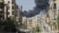 Smoke rises after a Syrian Air Force fighter jet launched missiles in the northwestern city of Aleppo on September 5.