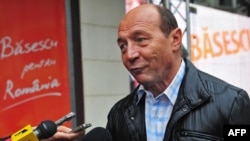 Incumbent Romanian President Traian Basescu speaks to reporters.