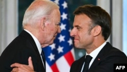 French President Emmanuel Macron (right) shakes hands with U.S. President Joe Biden during an official state dinner at the Presidential Elysee Palace in Paris on June 8.