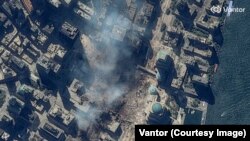 The site of the World Trade Center in New York City seen on September 15, 2001, as smoke rises from the September 11 attacks.<br><br>The 2026 image of the rebuilt site was captured on June 25.