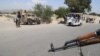 Afghan security forces stop vehicles at a checkpoint in Jalalabad.