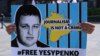 Kateryna Yesypenko holds a poster calling for her husband to be freed. 