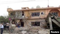 Residents gather at the site of a deadly bomb attack in the town of Tuz Khurmatu, north of Baghdad, on October 31.