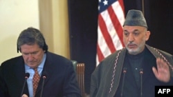 Holbrooke and Karzai at a press conference earlier this year