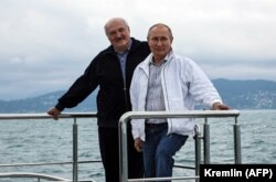 Russian President Vladimir Putin (right) and his Belarusian counterpart, Alyaksandr Lukashenka, pose on a boat during trip on the Black Sea earlier this year.