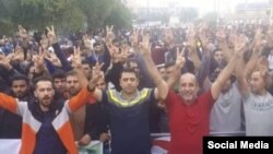 Haft-Tappeh sugar cane factory workers protesting low and unpaid wages. In center is a labor leader, Esmail Bakhshi, who is currently in jail. November 2018.